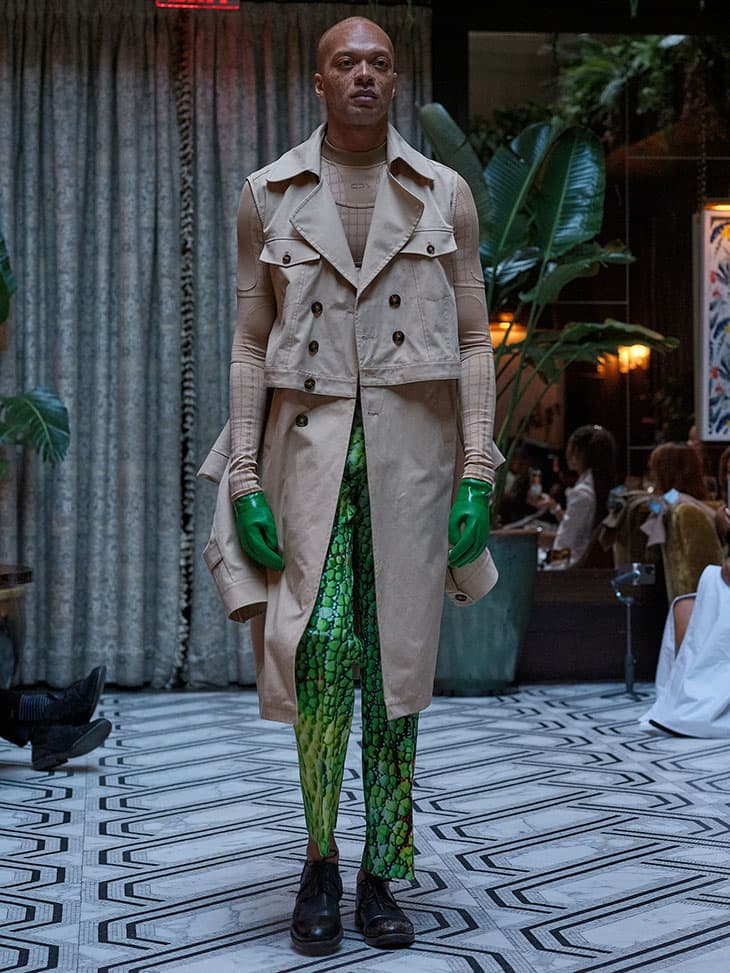 Beige trench coat with green reptile-print pants