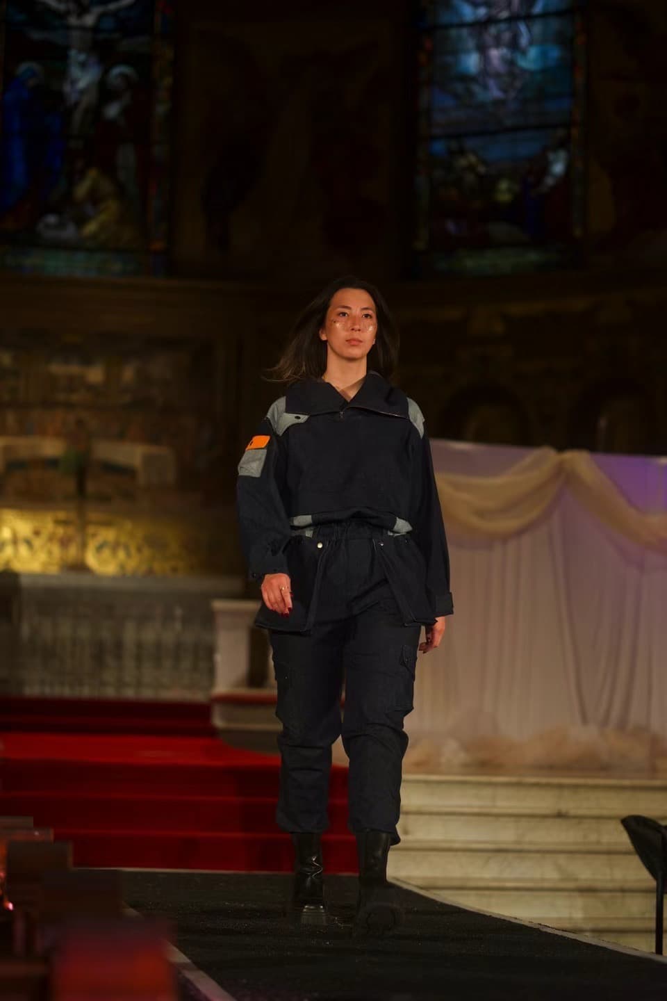 Model in utility-inspired sustainable outfit